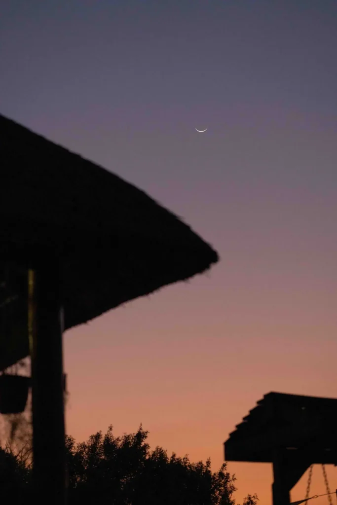 The lodge exterior under a crescent moon